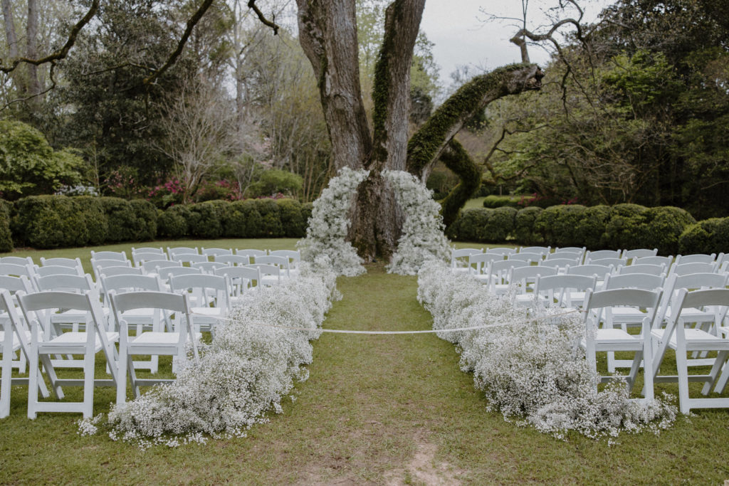 Ceremony space at Meadowlark 1939 filled with baby's breath and large trees
